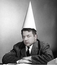 Conner edited into a vintage photo, arms crossed, wearing a dunce cap
