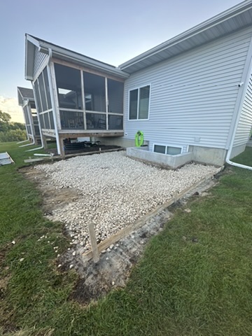 Before: a bare gravel pad behind the house